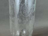 a glass vase with a design on it sitting on a table