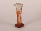 a glass vase with a red and white design on it