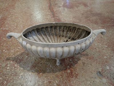a large white bowl sitting on the floor in a room