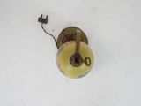 a donut hanging from a wall light on a white wall