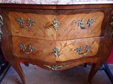 a marble top chest of drawers on display in a room
