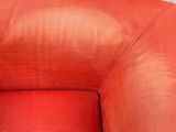a cat that is sitting in a red chair