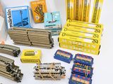 a lot of different types of train parts on the table