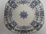 a blue and white plate on a white table