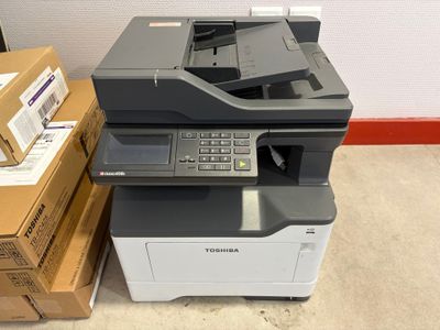 a printer sitting on top of a stack of boxes