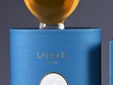 an image of a bottle of perfume sitting on top of a blue box