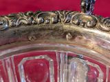 a silver plate with a bird on top of it
