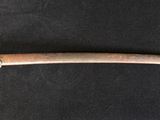 a close up of a sword on a black surface