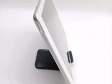 a tablet that is sitting on a stand on a table