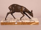 bronze sculpture of a deer on a marble base