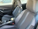the interior of a car with grey and black seats and a steering wheel