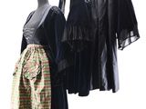 three dresses hanging on a clothes rack in front of a white background