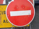 a red and white no entry sign next to a red and white no entry sign