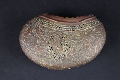 a small metal box with a decorative design on it