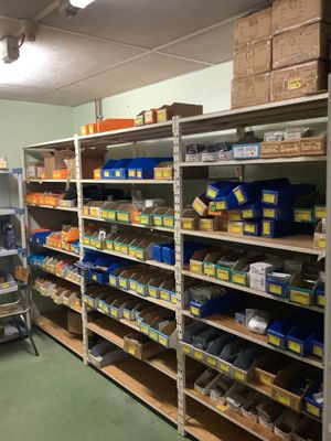 a room with shelves and bins of food in it