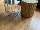 two tables that are on the floor in the living room