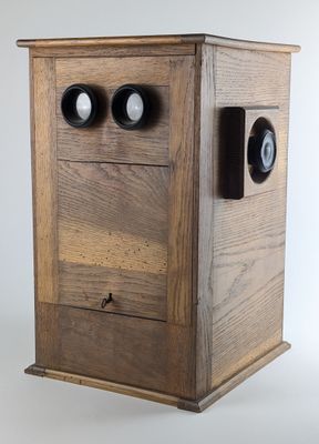 a wooden box with two eyes on top of it