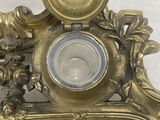 a gold clock with a bird on top of it