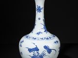 blue and white vase with birds and flowers on a black background