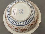 a white bowl with a blue and red design on it
