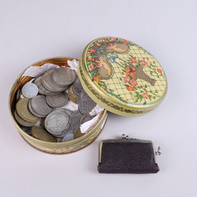 a small metal box with coins inside of it