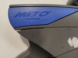a close up of a blue and black gun on a white surface