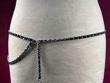 a close up of a mannequin torso with a chain around it