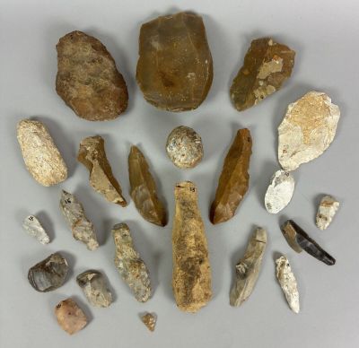 several different types of rock and stone tools displayed on a white surface