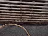 a close up of a metal grill with a hose