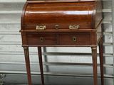 a small desk with a drawer on it in front of a wall