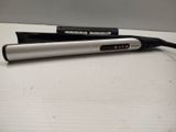 a silver and black hair dryer and a black and white hair brush