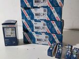 several boxes of toothpaste sitting on top of each other on a table