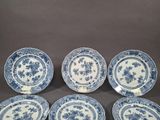 six blue and white plates with floral designs on them