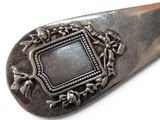 a silver spoon with a picture frame on it