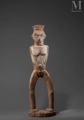 an old wooden statue of a man with his arms crossed