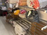 many rolls of fabric on the shelves in the store