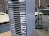 a metal filing cabinet with many drawers on top of it