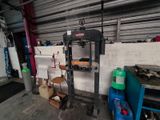 a machine that is sitting in a garage next to a wall