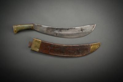 two knives are sitting side by side on a gray surface