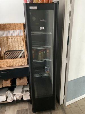 a black refrigerator with a glass door in a kitchen