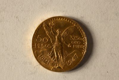 une pièce d'or représentant une femme, sur un fond blanc