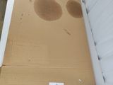 a cardboard box with holes in it sitting on the floor