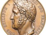 gros plan d'une pièce de monnaie sur laquelle figure une tête d'homme