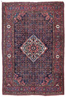 an antique persian rug with a medallion design on a blue ground