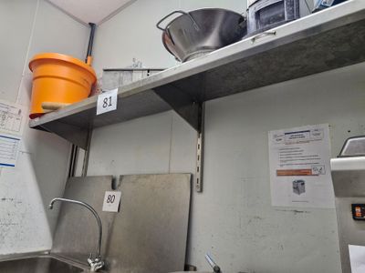 a kitchen with a sink and a counter with a pot and pans on it