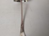 a spoon and a spoon rest on a white surface