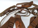a lot of belts that are on a white table