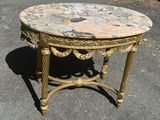 a small table with a marble top on the street