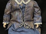 a doll that is sitting on a black surface