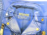 a blue purse with gold zippers and a moschino logo on it
